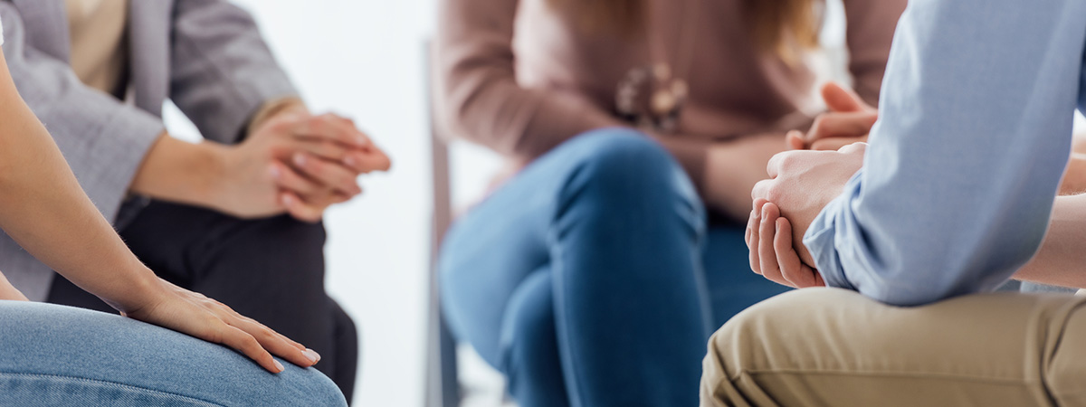 People sitting in circle for group therapy